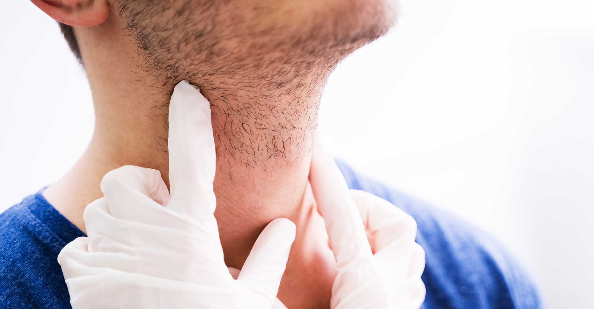 Doctor Performing Physical Exam Palpation Of The Thyroid Gland